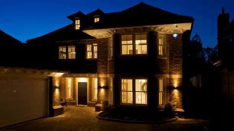 Exterior of home at night with lights on inside