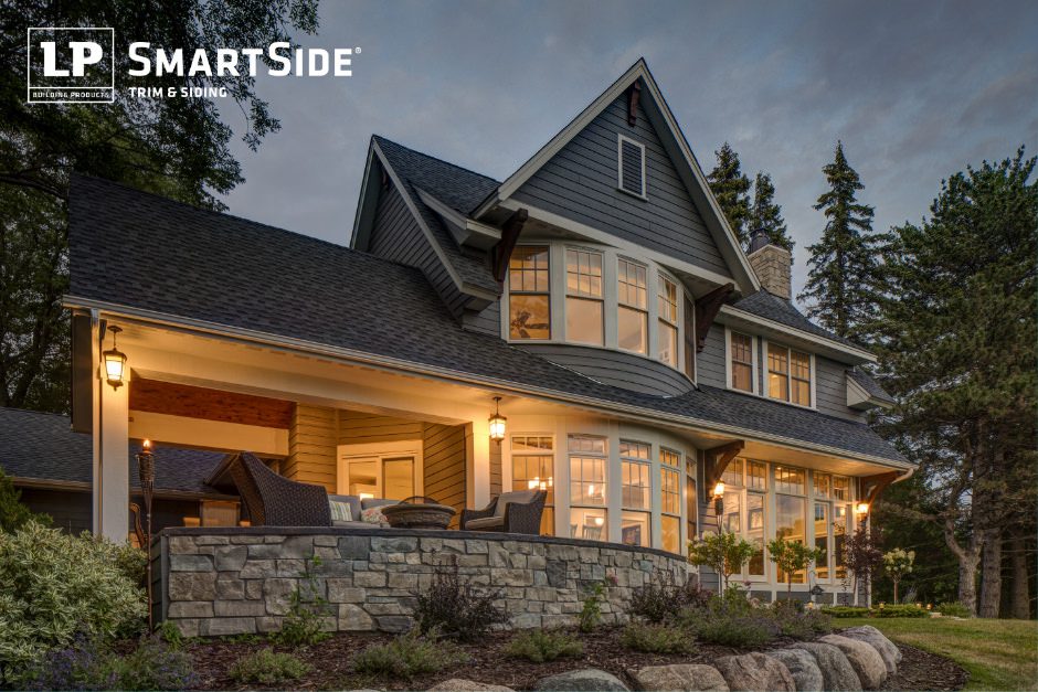 Large home lit up at dusk featuring LP SmartSide trim and siding